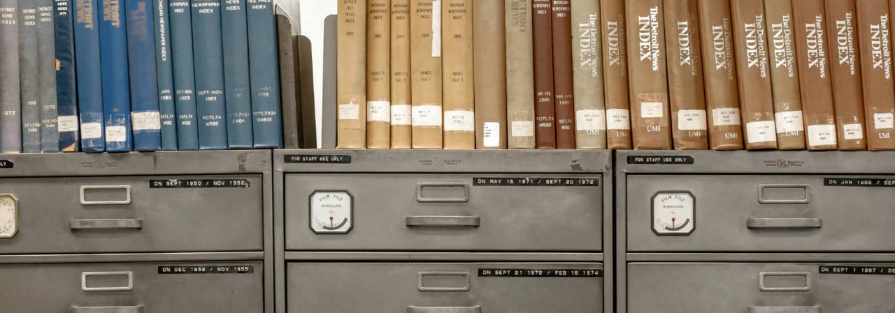 Metal filing cabinets with books on top